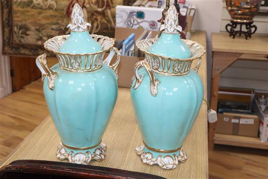 A pair of Ridgway turquoise and gilt ground two handled lidded vases, each painted with panels of garden flowers, height 42cm
